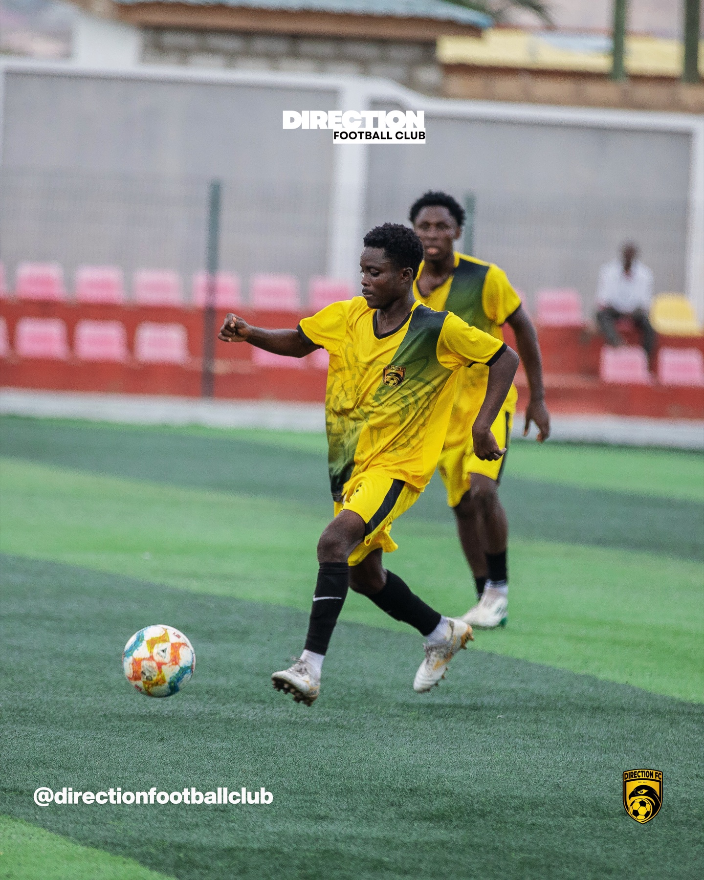 A Direction FC player shooting the ball during a match.